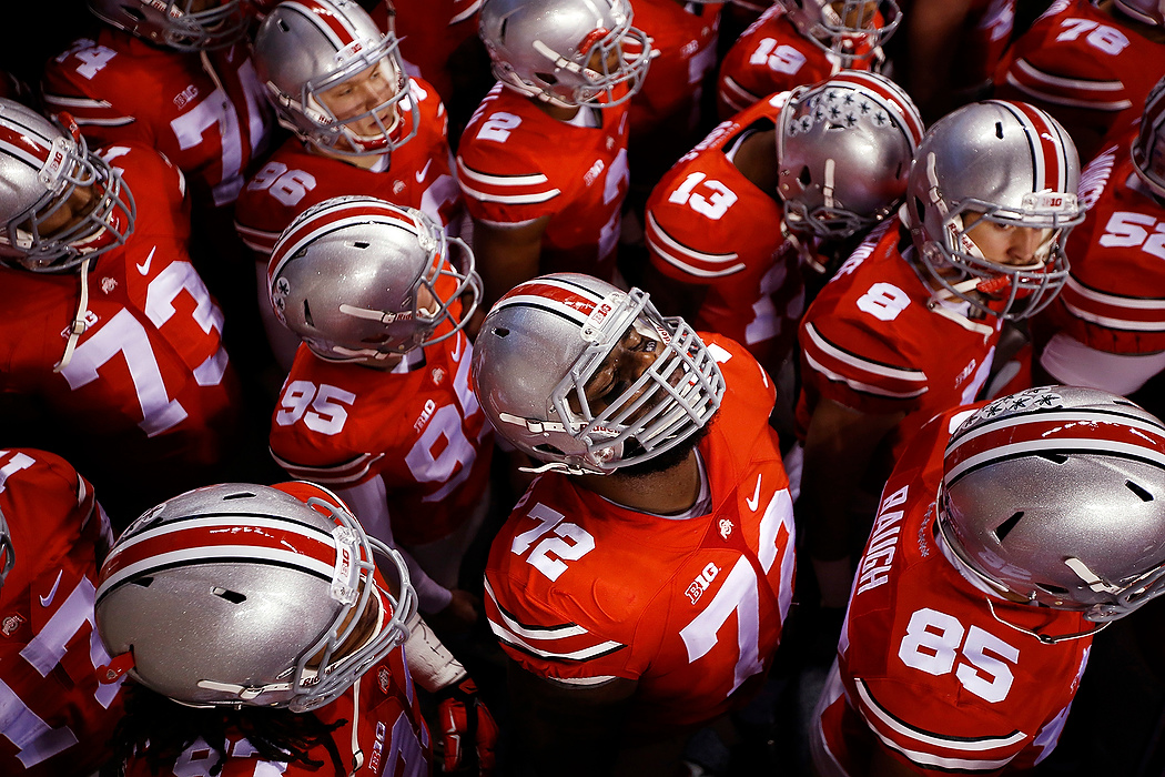 First Place, Photographer of the Year - Large Market - Eamon Queeney / The Columbus DispatchOhio State defensive lineman Chris Carter (72) pauses with his eyes closed for a moment before the team runs on to the field for the Big Ten Championship game against the Wisconsin Badgers at Lucas Oil Stadium in Indianapolis. Ohio State went on to shock the nation by defeating the Badgers 59 - 0.