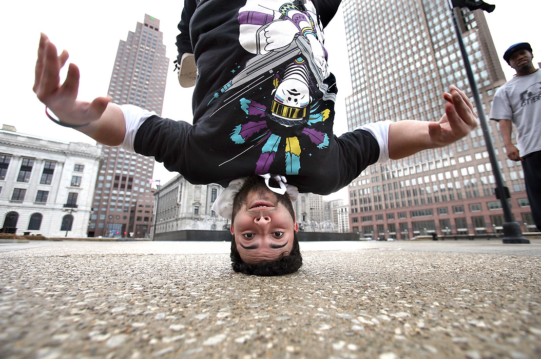 Second Place, Photographer of the Year - Large Market - Lisa DeJong / The Plain DealerAntonio Guerra, 21,  or "Tony Tycoon", practices a break dance move called a "head stall" near the Cleveland War Memorial Fountain. Guerra and fellow break dancers Daisun Santana, 25, and Elliott Durant, 27, were out in different downtown locations today to film dance moves to promote Daisun Santana's studio called CityBreaks Studio.