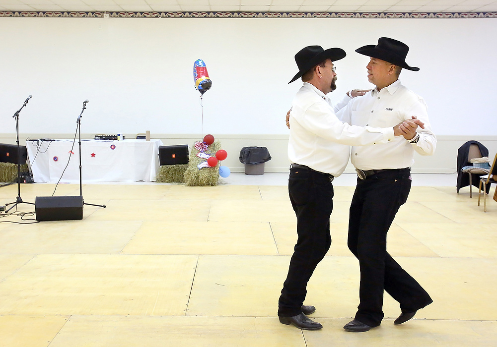 Second Place, Photographer of the Year - Large Market - Lisa DeJong / The Plain DealerTommy Tharp, 52, left, and his partner Chris Samonte, 57, of Phoenix, dance a western swing as they practice on an empty dance floor at the International Gay Rodeo Association's rodeo competition for the 2014 Gay Games at the Summit County Fairgrounds in Tallmadge. The dance floor will be crowded tonight during the Wild West Rodeo Dance. Athletes from all over the United States and the world compete in roping events, barrel racing and steer riding. This is the first time IGRA has coordinated their rodeo with the Gay Games.