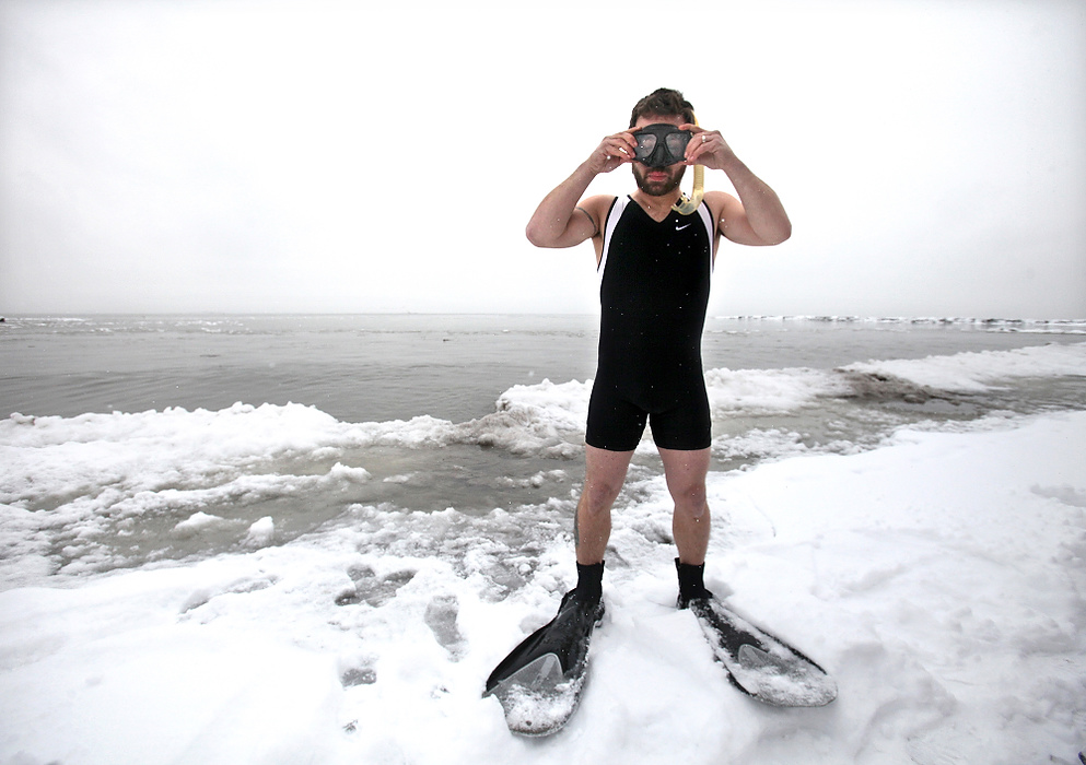 Second Place, Photographer of the Year - Large Market - Lisa DeJong / The Plain DealerTony Shultz of North Ridgeville prepares his scuba mask moments before taking his very first sub-freezing dip in Lake Erie for The Polar  Plunge at Huntington Beach in Bay Village.  Shultz, a member of Christ the King Church in North Olmsted, brought in the new year with their annual fundraiser for Rescuing the Perishing, a ministry that feeds the homeless.  About 50 people, ages 16 to 61, braved the heart-stopping temperatures, making sure even their heads were underneath the water, the only rule for the plunge.The fundraiser, their only one for the year, brought in $18,000 last year.  