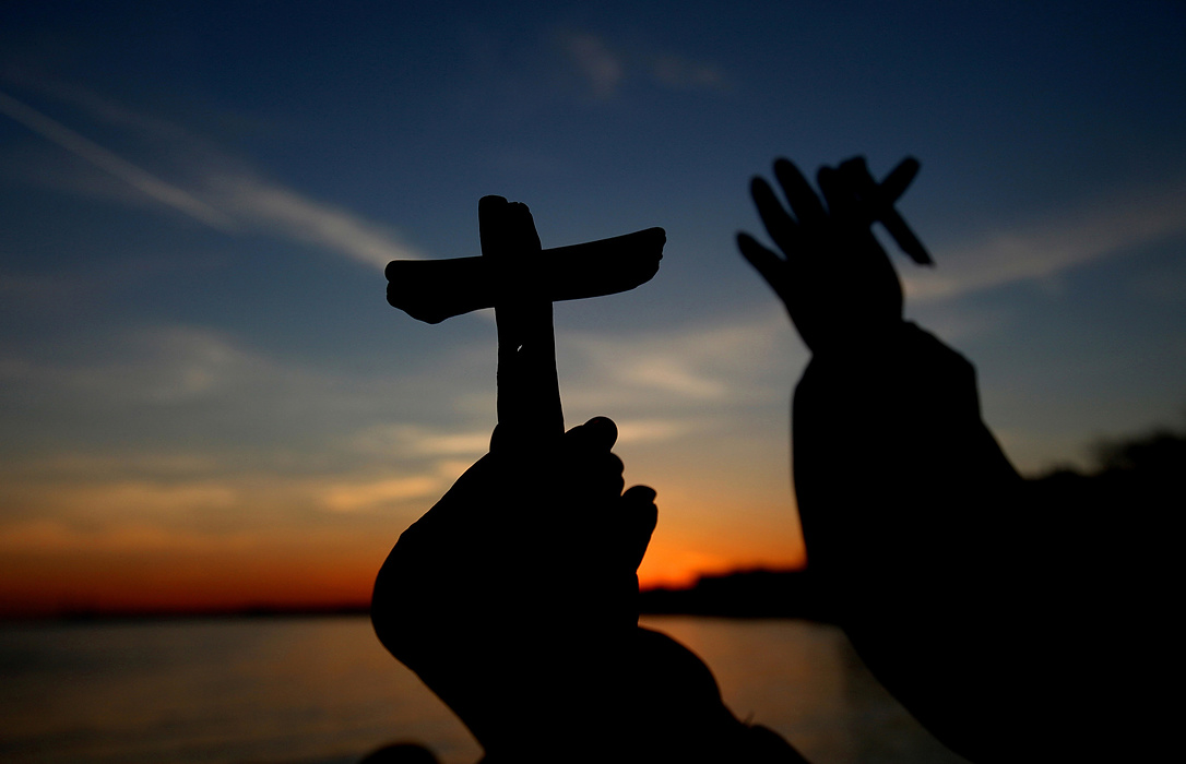 Second Place, Photographer of the Year - Large Market - Lisa DeJong  / The Plain DealerWorshippers hold crosses made of driftwood as they watch the sun come up during community Easter sunrise service on the new pier at Kenneth J. Simms Park in Euclid. Christians from around the world are celebrating the resurrection of Jesus Christ from the dead today on Easter Sunday.  Dr. Jan Yandell, pastor of East Shore United Methodist Church in Euclid, led the sunrise service with her guitar and a singing meditation bowl. "The power of seeing the sun rise over the lake, it's like the sun is walking across to meet you, " Yandell said. "As the symbol of Christ, he meets us here." 