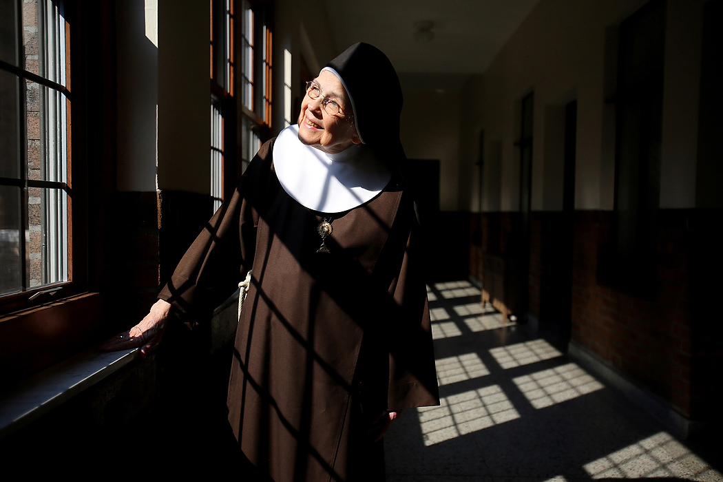 Second Place, Photographer of the Year - Large Market - Lisa DeJong / The Plain DealerMother Mary Thomas, 81, says she has been blessed by good light inside the Adoration Monastery where she has lived for 55 years.  No more than five feet tall, Mother Thomas is a member of the Poor Clares of Perpetual Adoration, a cloistered order tracing its origins to the early 13th century. These days, she toils cheerfully on a mural many times her size. Currently, Mother Thomas, 81, spends hours on her knees painting a 30 x16-foot mural that she hopes to present to the pope when he arrives in Philadelphia in September.  "Art is chiefly a prayer for me, an expression of my love for God and His people," she said. Mother Mary Thomas has painted in vivid colors for over 60 years, influenced by studying mural painting in Mexico in her early 20s. A teacher encouraged her to go to the Chicago Institute of Art because, she was told, her work already reflected the influence of Diego Rivera, the famed Mexican muralist. Later, she would work with David Alfaro Siqueiros, a muralist in Mexico. After World War I, the Mexican Muralism style evolved with the intent of creating public art as visual narrative, especially as a means of social commentary and historical perspective.  In 1958, at the age of 25, she went to Rome to further study and paint. During an Easter prayer vigil at St. Peter's Basilica, she said, she was overcome with an intense sense of joy and knew then that joining a religious order was her vocation.  "If you told me then that I would end up in a cloistered order of nuns, I would not have believed it," she said. 