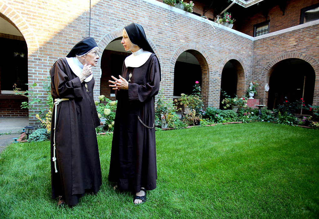 Second Place, Photographer of the Year - Large Market - Lisa DeJong / The Plain DealerMother Mary Thomas, 81, left, visits with Sister Mary Joseph, 51, in the garden of the Adoration Monastery at The Church of the Conversion of St. Paul.  Mother Mary Thomas, 81, has lived here as a cloistered nun of the Poor Clares of Perpetual Adoration for 55 years. She is one of the 18 nuns that live here in silence. Speaking is only allowed at certain times of day. 