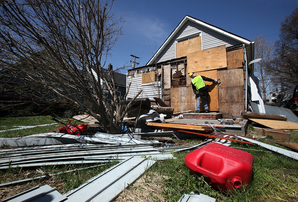 Second Place, Photographer of the Year - Large Market - Lisa DeJong / The Plain DealerBlaine Murphy boards up yet another abandoned house on Huss Avenue in Slavic Village. Vandals tore the old boards off. Murphy is working with the Slavic Village Development Corporation and combing the neighborhood for code violations, such open vacant homes. Murphy works nearly 12 hours a day to get closer to his 3,000 hours of community service. 