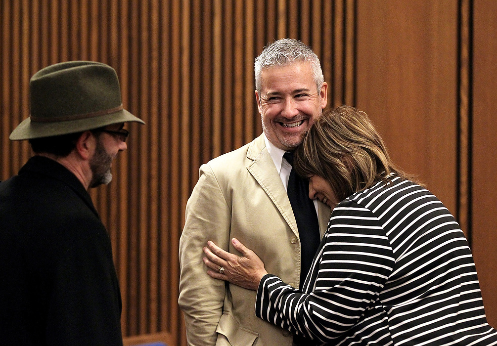 Second Place, Photographer of the Year - Large Market - Lisa DeJong / The Plain DealerBlaine Murphy laughs as neighbor and good friend Lynda Lewis laughs and cries at the same time on his shoulder after Judge Richard McMonagle lets him go home to Florida after serving less than his 3,000 hours of community service. The two have grown very close and Lewis is heartbroken on many levels that Murphy is leaving town. On left is councilman Tony Brancatelli, his de facto probation officer. Murphy is struck by the ironic friendships created by the unique sentencing by Judge McMonagle. Lewis says she will visit her "son" in Naples, Florida, every winter. 