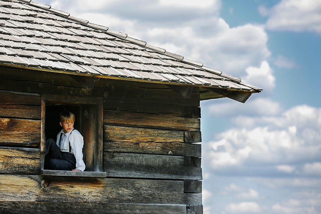 Third Place, Photographer of the Year - Large Market - Andy Morrison / The (Toledo) BladeJacob Thompson, 10, watches the action from a window of a log home during the First Siege at Fort Meigs in Perrysburg.