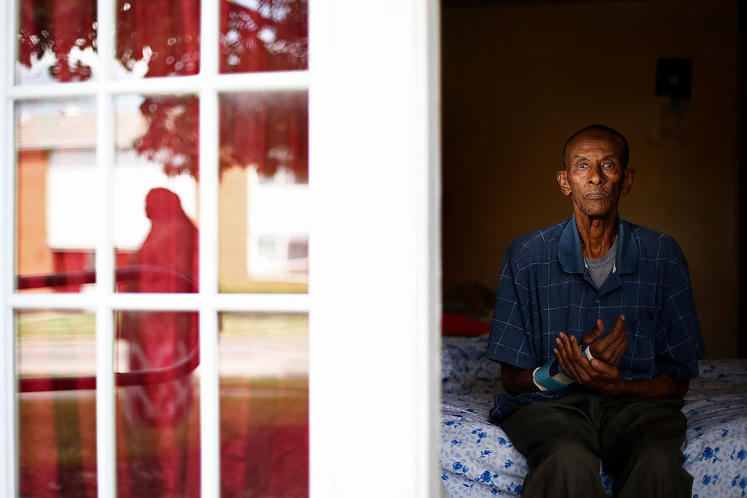 First Place, Photographer of the Year - Large Market - Eamon Queeney / The Columbus DispatchElmi Nur, 65, sits on his bed and holds his damaged right arm as he poses for a photograph in his Capital Park Apartment in Northeast Columbus. Nur was attacked and beaten steps from his home about two months ago by a group of four men from outside of the neighborhood. The police were notified but no one was apprehended. The apartment complex is home to a large population of Somalis but recently many Somalis have been preyed upon by outsiders. 