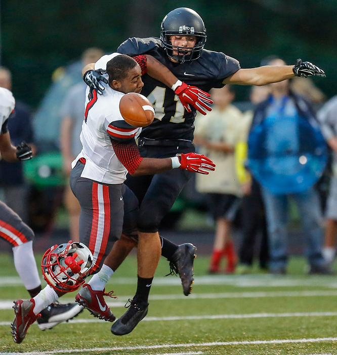 Third Place, Photographer of the Year - Large Market - Andy Morrison / The (Toledo) BladeToledo Central Catholic High School player Stephon Campbell (7) loses his helmet as he breaks up a pass intended for Perrysburg High School player Jake Myers (11) during the first quarter in Perrysburg.