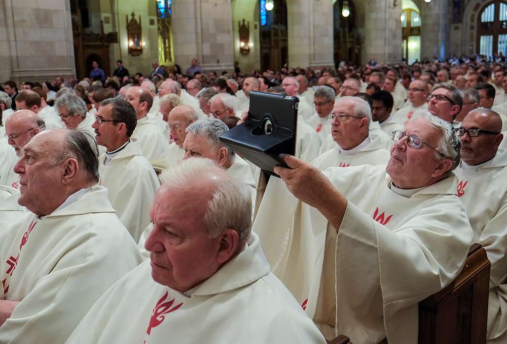 Third Place, Photographer of the Year - Large Market - Andy Morrison / The (Toledo) BladeA priest captures the occasion with his iPad during the installation ceremony of Toledo's new Bishop, the Most Reverend Daniel E. Thomas, at Our Lady, Queen of the Most Holy Roasary Cathedral.