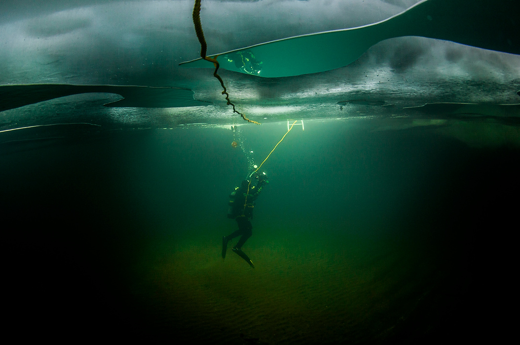 Third Place, Photographer of the Year - Large Market - Andy Morrison / The (Toledo) BladeRich Synowiec heads back to the exit hole after completing a dive on a shipwreck under 20 inches of ice on Lake Erie near Colchester, Ontario. Trapped air on the underneath of the ice provides a mirror-like effect. 