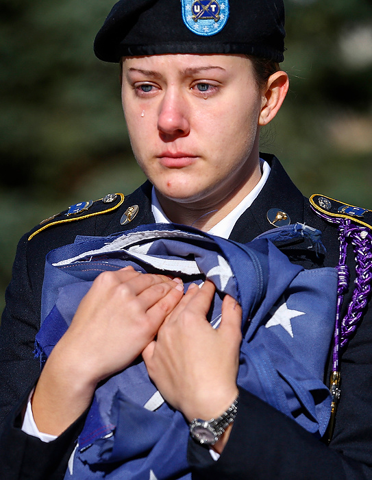 Third Place, Photographer of the Year - Large Market - Andy Morrison / The (Toledo) BladeAn emotional Michelle Janollari holds an American flag during the playing of the National Anthem, as the Student Veterans of America UT Chapter retires several American flags during a ceremony near the Student Union at the University of Toledo. The Avon native said the event had a real emotional impact so close to Veteran's Day.