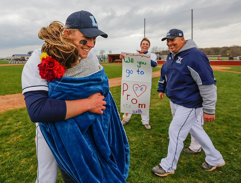 Third Place, Photographer of the Year - Large Market - Andy Morrison / The (Toledo) BladeLake High School player Joel Densic gets a hug from senior Emily Ervin after she accepted his prom proposal.  Densic surprised Ervin with the proposal after the Flyers defeated Genoa High School 2-1.