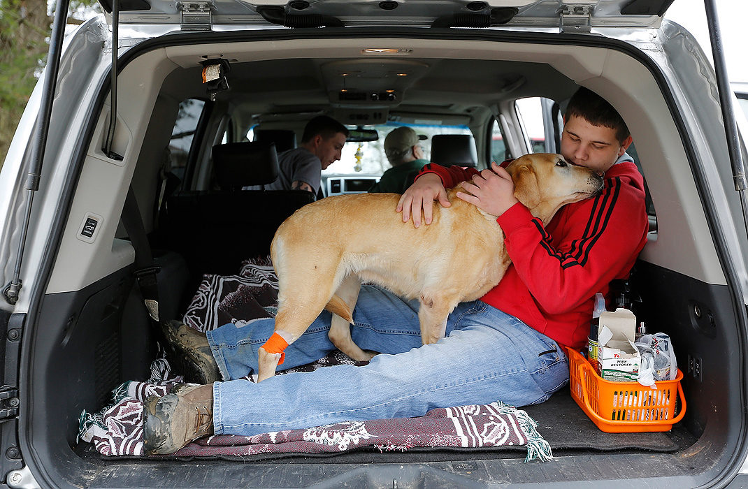 First Place, Photographer of the Year - Large Market - Eamon Queeney / The Columbus DispatchJordyn Wood, 16, snuggles with Buffy, the last of his grandfather Don Butts' 18 hospitalized labradors to be released from the Masterson Veterinary Clinic, as they get ready for the car ride home. "It's been hard on grandpa," said Jordyn. Last week between Wednesday and Friday, 18 of Butts' labradors were poisoned with ethylene glycol, commonly known as antifreeze, and had to be rushed to Masterson Veterinary Clinic once Don realized something was wrong after his dogs began to have seizures. An 8 year-old male named Storm was the only dog to die and his diagnosis saved the rest. "I found Stormy like that," said Jordyn. "It's not something you want to see again, but Stormy saved the lives of 17 other dogs." 