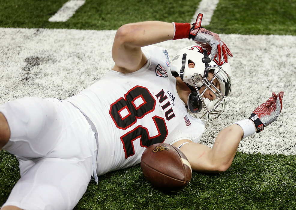 Third Place, Photographer of the Year - Large Market - Andy Morrison / The (Toledo) BladeNorthern Illinois University player Chad Beebe (82) rolls over and looks at his arm after breaking it on a play during the first quarter of the MAC football championships against Bowling Green State University at Ford Field in Detroit.