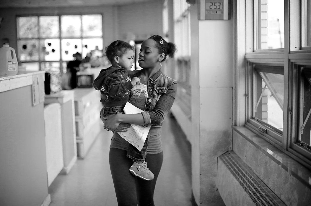 Third Place, Photographer of the Year - Large Market - Andy Morrison / The (Toledo) BladeCre'Ana Bell tries to cheer up her grumpy two-year old son Cedyn Bell as she picks him up from daycare at the Catholic Club in Toledo.