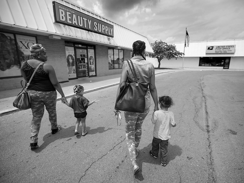 Third Place, Photographer of the Year - Large Market - Andy Morrison / The (Toledo) BladeLaChela Benton and her daughter Za'Naya Flowers, 2, left, and Cre'Ana Bell and her son Cedyn, 2, go shopping for beauty supplies for graduation, 