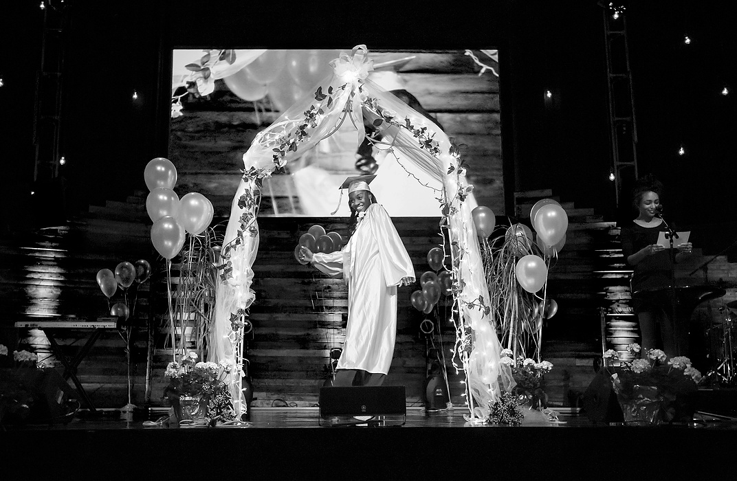 Third Place, Photographer of the Year - Large Market - Andy Morrison / The (Toledo) BladeCre'Ana Bell walks across the stage as she's introduced during the 10th Annual Commencement Exercises for Polly Fox Academy at Cedar Creek Church.