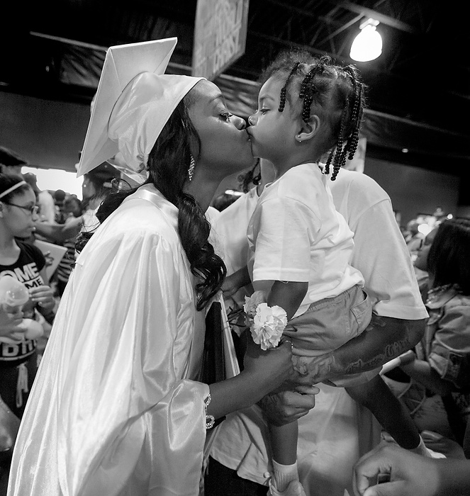 Third Place, Photographer of the Year - Large Market - Andy Morrison / The (Toledo) Blade Cre'Ana Bell gets a kiss from son Cedyn Bell, 2, after the 10th Annual Commencement Exercises for Polly Fox Academy at Cedar Creek Church.