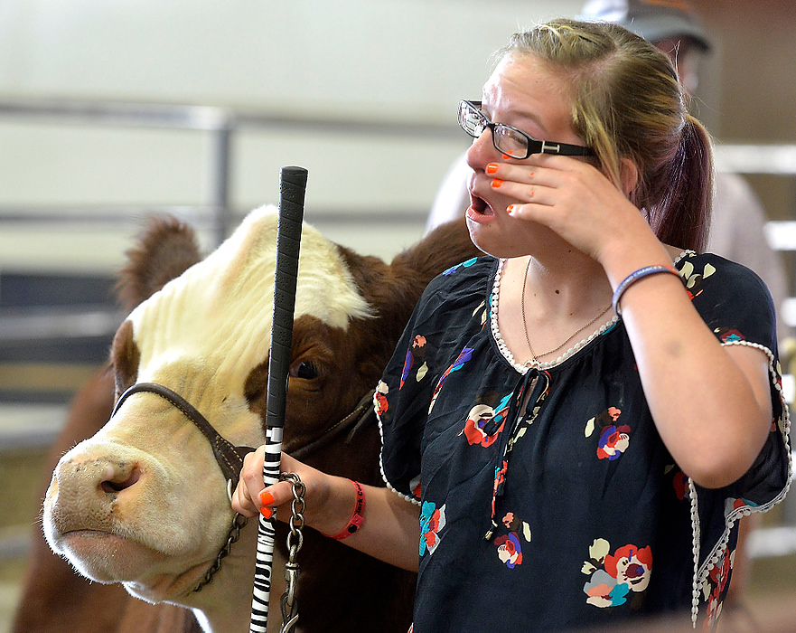 Third Place, Photographer of the Year - Small Market - Bill Lackey / Springfield News-SunMcKenzie Palmer, 15, wipes away a tear as she waits to auction off her Reserve Champion steer Friday at the fair.