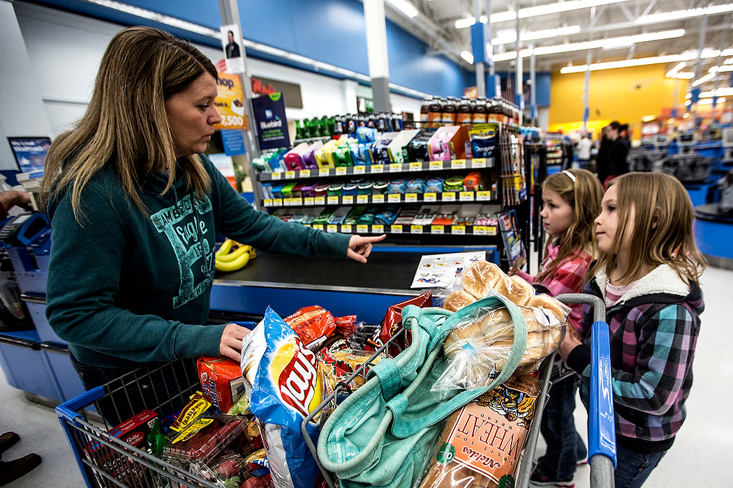First Place, Photographer of the Year - Small Market - Jessica Phelps / Newark AdvocateGrocery shopping is always an ordeal for Jesse Deeds. With eight children in tow she usually stops at Aldi and Walmart and fills up two carts. Jesse and her husband have four children of their own and after fostering 35 children they adopted four more. The adoptive children and the biological children play and fight as though they were all blood related. 