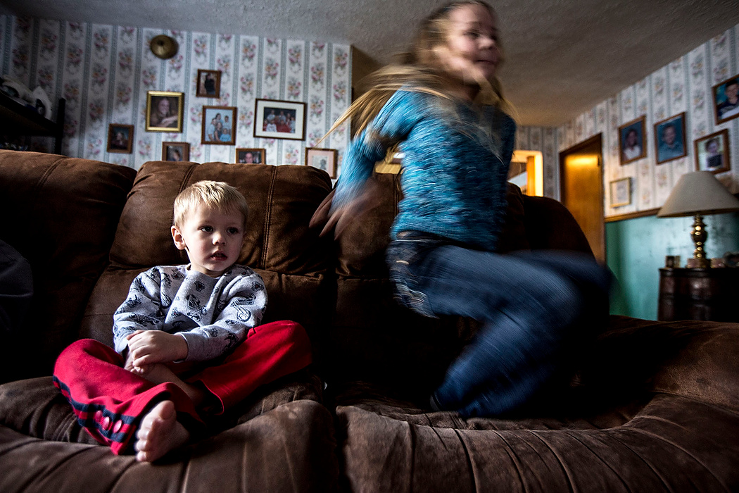 First Place, Photographer of the Year - Small Market - Jessica Phelps / Newark AdvocateJu Ju jumps on the couch while her brother Titus watches a movie. The two siblings are the youngest of the Deeds children, and were both  born after their parents began fostering children and have know no other way of life. 