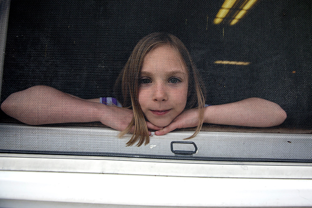 First Place, Photographer of the Year - Small Market - Jessica Phelps / Newark AdvocateAmelia, who came to live with the Deeds family as a foster child before being adopted by them stares out the window. Amelia doesn't remember much of her previous life because she was so young when she was brought to her new family. 