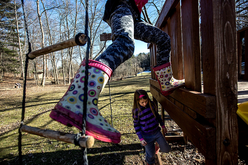 First Place, Photographer of the Year - Small Market - Jessica Phelps / Newark AdvocateThe pack of Deeds' children all jumped at the chance to finally play outside as soon as the weather began to warm up in March. Amelia climbs up ad down the ropes and ladders while her younger sister Ju Ju runs through the mud. 