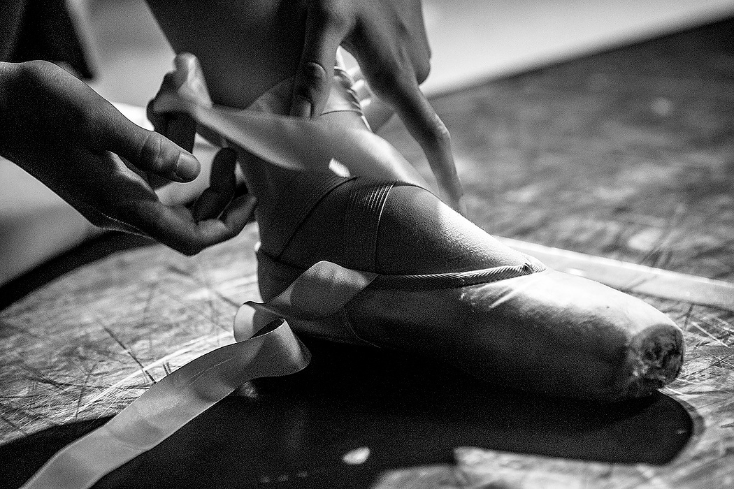 First Place, Photographer of the Year - Small Market - Jessica Phelps / Newark AdvocateA dancer wraps her pointe shoe before rehearsals begin.