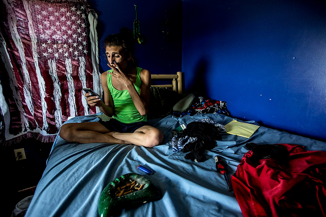 First Place, Photographer of the Year - Small Market - Jessica Phelps / Newark AdvocateCarl smokes on his bed while listening to music and reading old texts from his ex. Carl had moved in with Michele to escape trouble at home. While Michele was using methamphetamine he began to use it as well and is now fighting off his own addiction. 