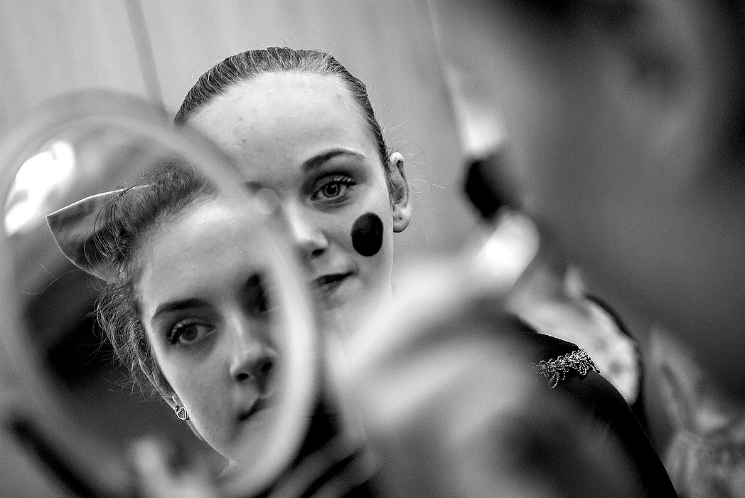 First Place, Photographer of the Year - Small Market - Jessica Phelps / Newark AdvocateJordan Gummere and Abigail Buchanan help each other with make-up before performing an abridged version of the Central Ohio Youth Ballet's production of " The Nutcracker" at the Granville Public Library. 