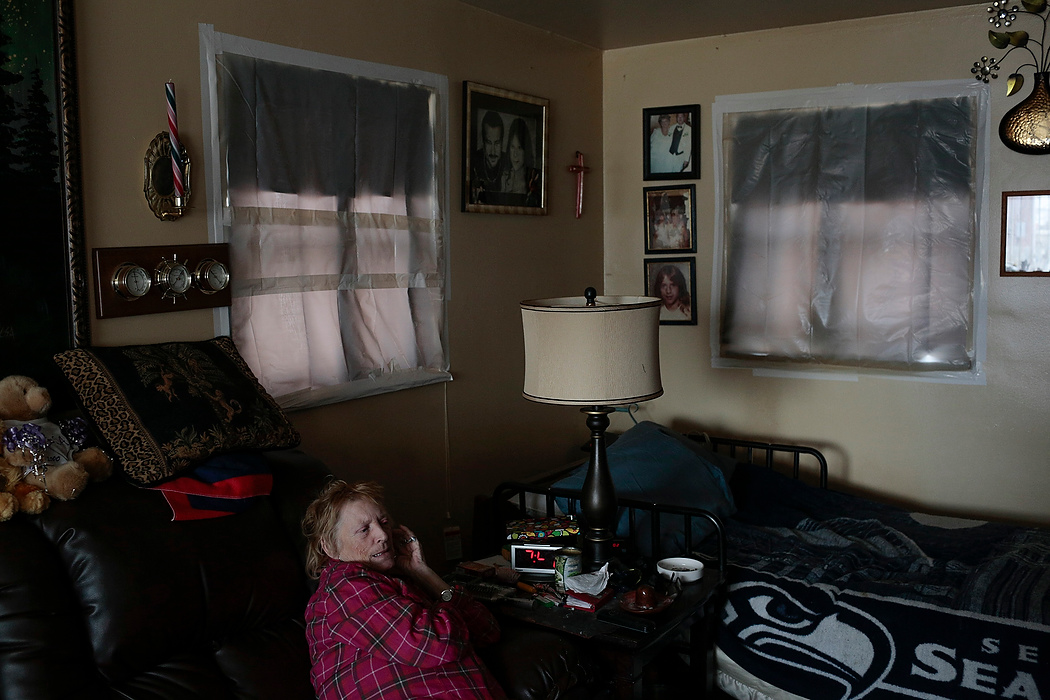 Second Place, Photographer of the Year - Small Market - Joshua A. Bickel / ThisWeek Community NewsRose Neefe sits on her couch in the living room of her apartment at the Commons at Royal Landings in Whitehall. Neefe and her husband, Robert, use an electric fireplace to stay warm and have placed plastic over the windows to keep heat in and cold air out. The apartment complex, which was the site of a 4-year-old boy's death after a stove being used to heat the home crushed him, has been reported for numerous code violations and lack of heat in some units.