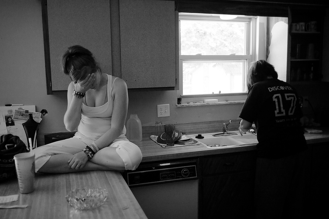 Second Place, Photographer of the Year - Small Market - Joshua A. Bickel / ThisWeek Community NewsBrittany Miller (left) is a recovering heroin addict. As a young teenager, Brittany experimented with marijuana and alcohol, moving to cocaine at age 14. "I used to try to be out of myself and I had a lot of self-esteem issues," she said. By age 3, Brittany's mother, Terri, right, had left her stepdad to reunite with Brittany's father. "I felt betrayed by my mom," she said. Eventually, Brittany started using OxyContin, a prescription painkiller, to numb her feelings of pain and inadequacy. In recent years, Ohio laws have cracked down on the distribution of these prescription opioids, making them more expensive and harder to obtain illegally. Many addicts then turned to heroin, a drug nearly identical to opiate painkillers, because it was cheaper and easier to find.