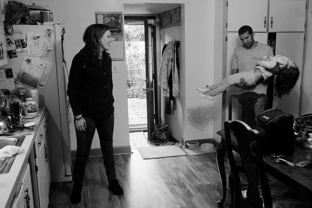 Second Place, Photographer of the Year - Small Market - Joshua A. Bickel / ThisWeek Community NewsBrittany laughs as her boyfriend, Deryk Tangeman, brings a sleepy Kalysta into the kitchen for breakfast before her first day of school in Reynoldsburg. After moving out of her mother's house, Brittany and Kalysta moved in with Deryk to a home they share with his mother. "He's not an addict in any way," Brittany said of Deryk. "And he for some reason cares abut someone like me."