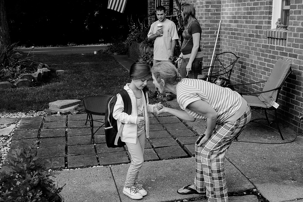 Second Place, Photographer of the Year - Small Market - Joshua A. Bickel / ThisWeek Community NewsBecky Tangeman, center right, the mother of Deryk, gives Kalysta some words of encouragement as she heads off to school in Reynoldsburg. Kalysta's father, Andrew Snell, top center, also came over to take his daughter to school with Brittany. Though Brittany and Andrew aren't together, they maintain a cordial relationship as friends.
