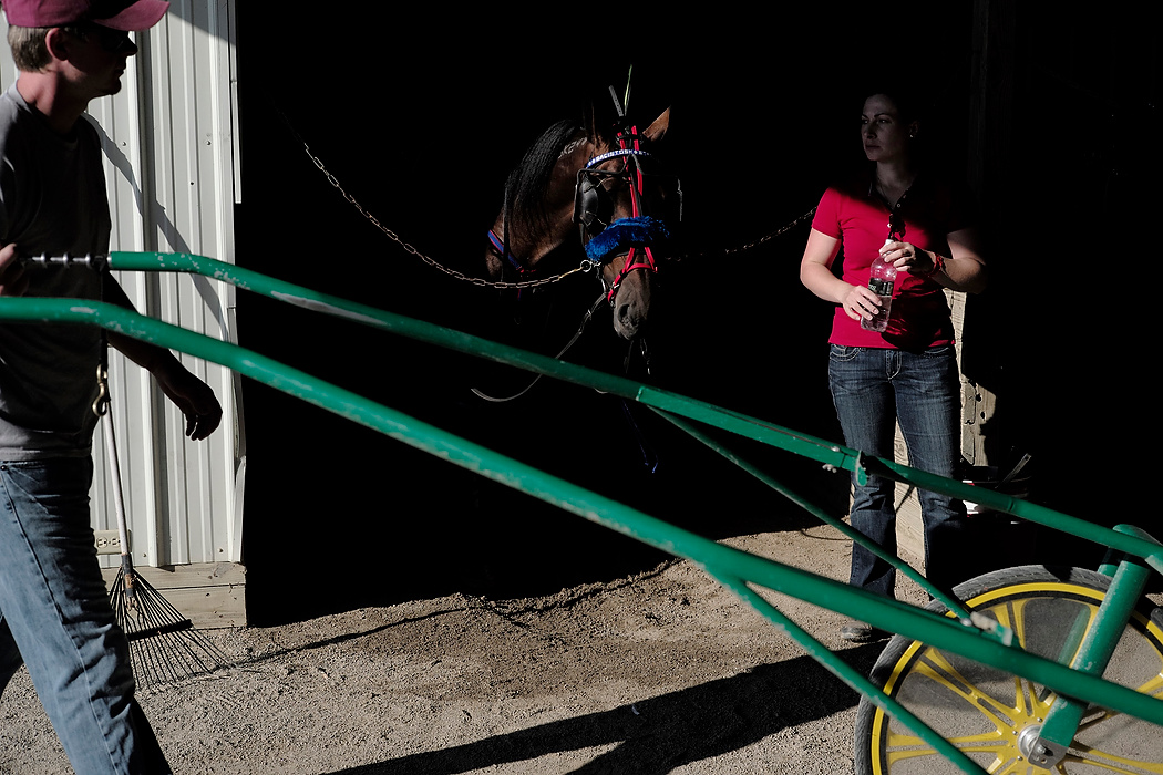 Second Place, Photographer of the Year - Small Market - Joshua A. Bickel / ThisWeek Community NewsTrainers move through the stables before a race during the Little Brown Jug at the Delaware County Fairgrounds.