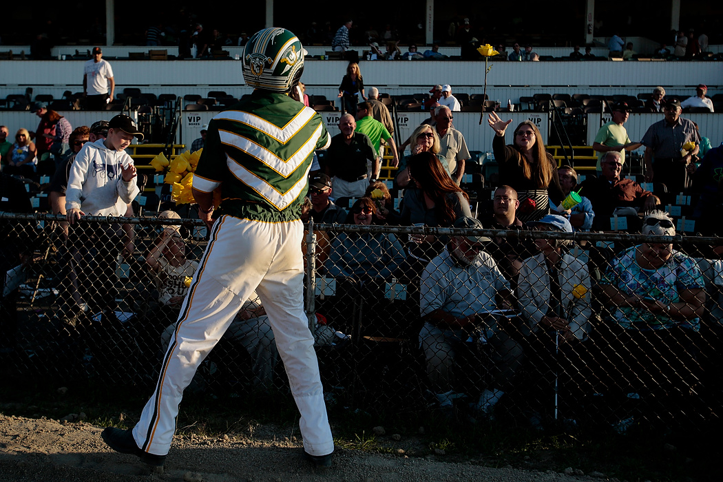 Second Place, Photographer of the Year - Small Market - Joshua A. Bickel / ThisWeek Community NewsDriver Yannick Gingras tosses a yellow rose to a fan in the crowd after winning the 69th Little Brown Jug with standardbred Limelight Beach  at the Delaware County Fairgrounds. As is tradition, the winner of the Jug hands out the flowers to fans following the final race.
