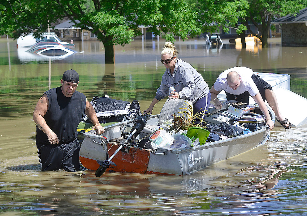 Third Place, Photographer of the Year - Small Market - Bill Lackey / Springfield News-SunChad Baker (left) and Jeremy Walker use a boat to help Baker's sister, Amy Baker (center) recover some of her belongings from her flooded apartment along Gerlaugh Road in Clark County. The apartment complex was evacuated earlier in the morning when several feet of water started flooding the apartments. 