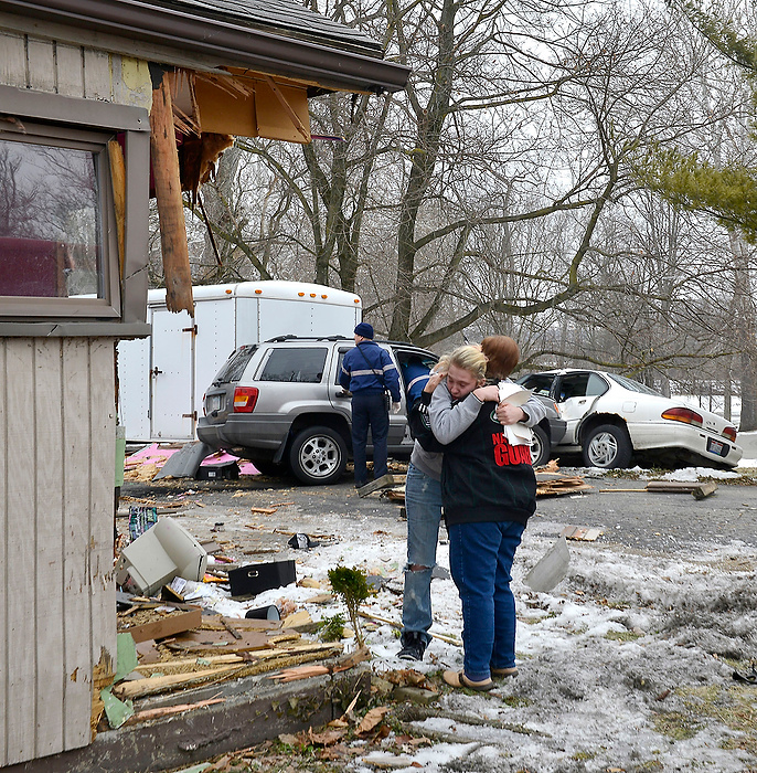 Third Place, Photographer of the Year - Small Market - Bill Lackey / Springfield News-SunLeAnna Miller is consoled by a friend after a car lost control and ran through her house, completely knocking off the corner of the structure in the 500 block of North Bechtle Avenue in Springfield. There were no injuries to the residents  but the driver of the car was transported to the hospital. The house suffered major structural damage.
