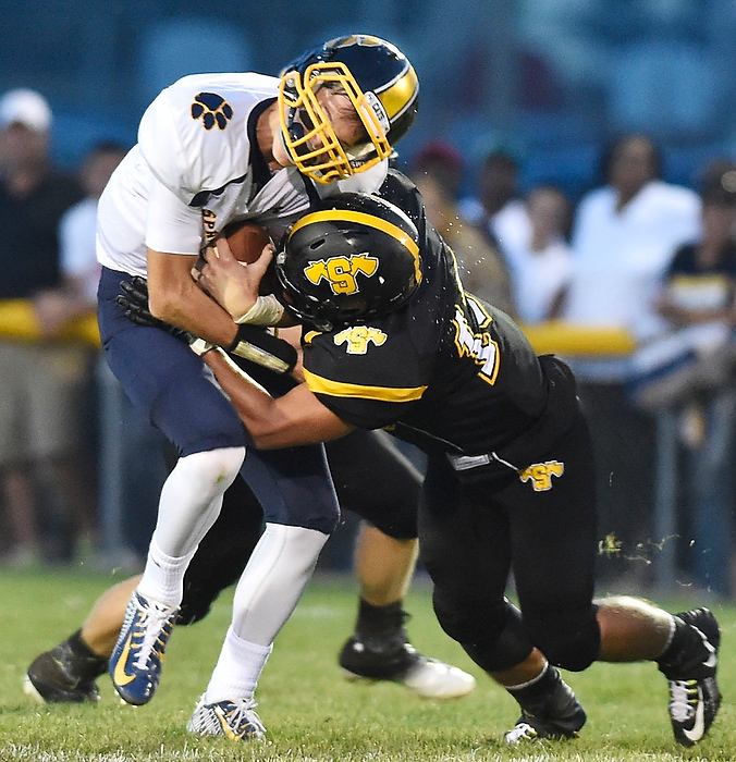 Third Place, Photographer of the Year - Small Market - Bill Lackey / Springfield News-SunShawnee's Trevor Deam hits Springfield quarterback Nick McCaughey as he runs with the ball during a game at Shawnee. 