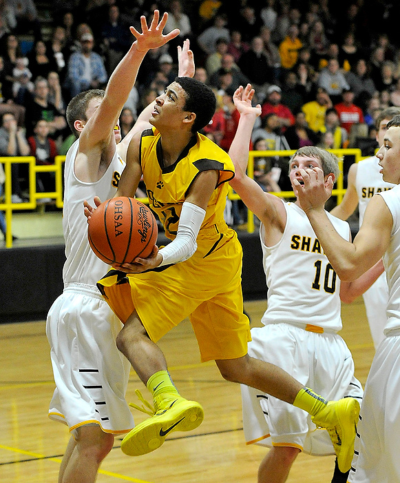 Third Place, Photographer of the Year - Small Market - Bill Lackey / Springfield News-SunKenton Ridge's Jordan Bailey soars between Shawnee's, from left, David Barnett, Andrew Tincher and Seth Gray as goes up for a lay-up.
