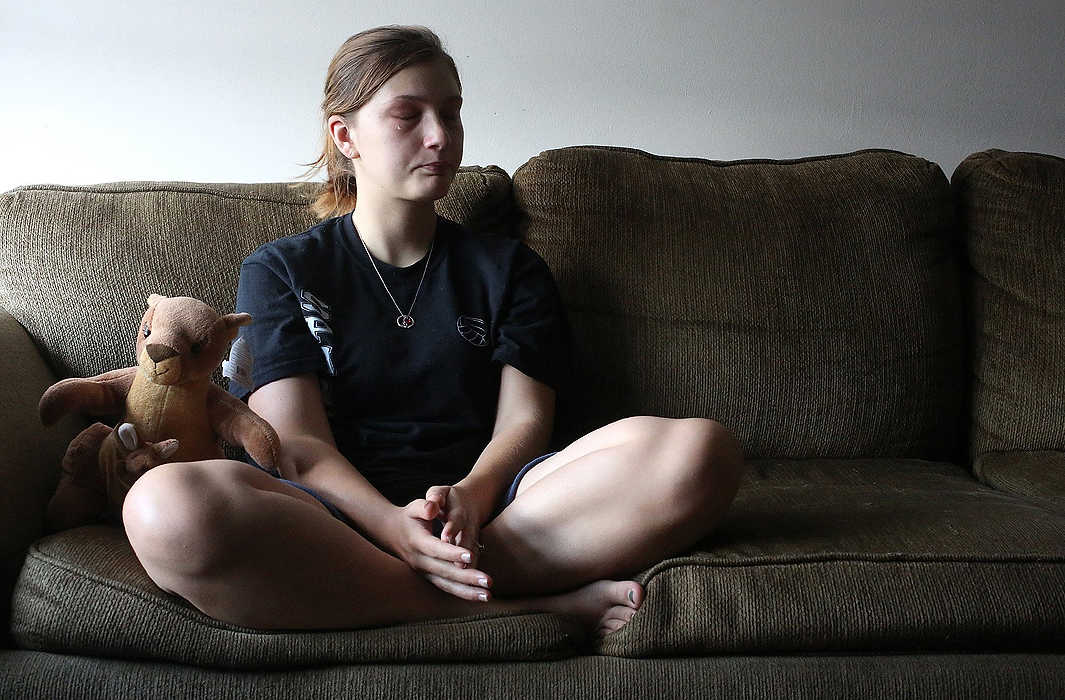 First Place, Portrait Personality - Brooke LaValley / The Columbus DispatchAlyssah Munson cries as she remembers the death of her son Andrew Alan Edwin Roth at just six days old during an interview in her home in Columbus. Andrew died due to complications from a genetic defect called Anencephaly which is caused by a lack of folic acid. A plush kangaroo sitting next to her plays a recording of the heartbeat of her son, which doctors were able to capture on audio before he died. 
