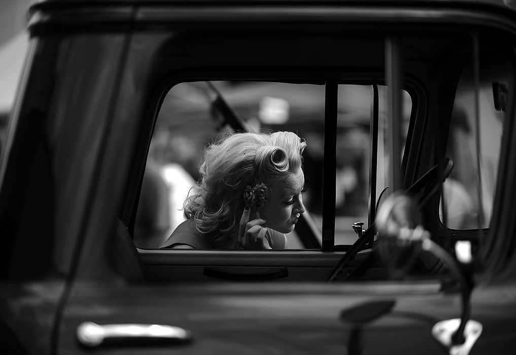 Second Place, Portrait Personality - Leah Klafczynski / Kent State UniversitySherry Basham adjusts her clip in the mirror of an old Chevy truck at the second annual Retro Rally Street Festival in Rock Island, Illinois. Basham took part in the pinup contest during the 50's inspired festival.