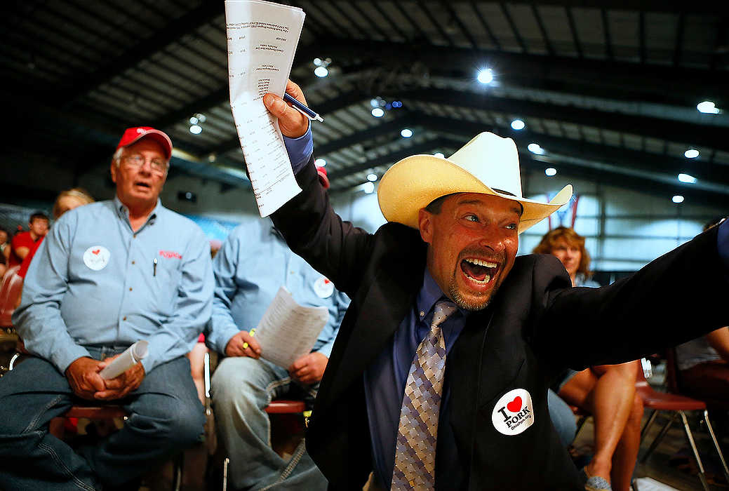 Third Place, Portrait Personality - Jenna Watson / Kent State UniversityAuctioneer Todd Woodruff shouts and waves his arms wildly after Steve Rausch and Associates bid the high price of 80,000 dollars for the grand champion market steer at the Ohio State Fair's Sale of Champions at the Celeste Center in Columbus. 