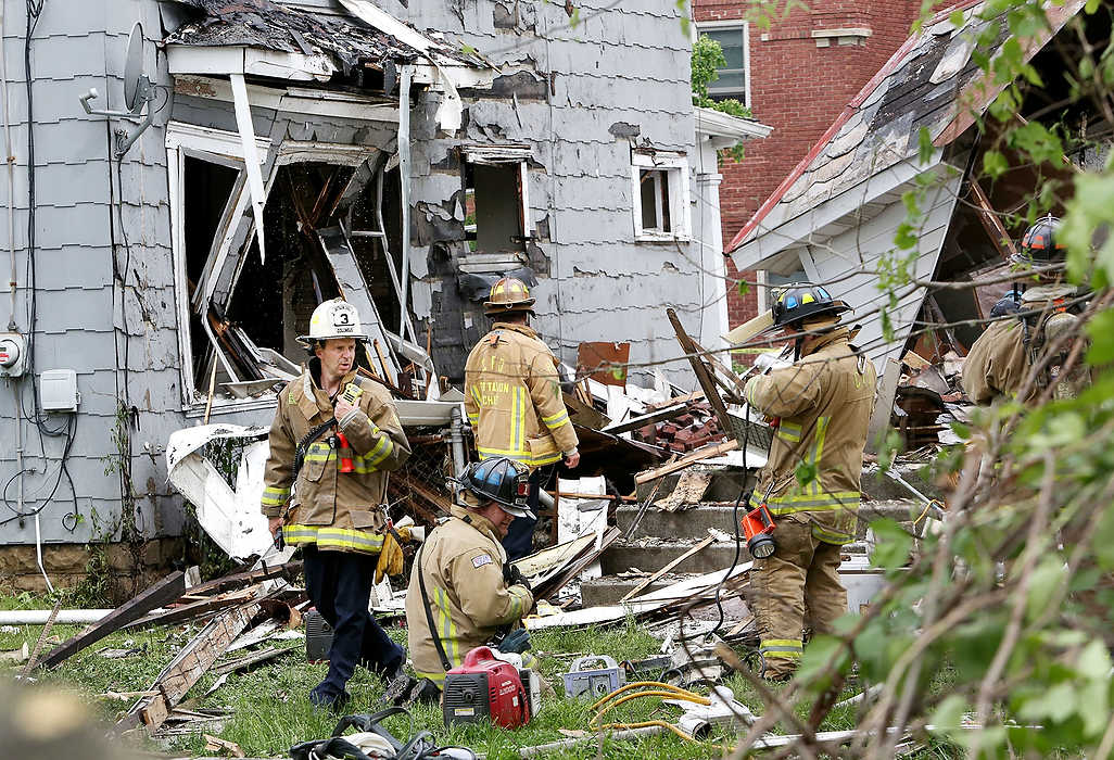 Third Place, Spot News - Large Market - Fred Squillante / The Columbus DispatchColumbus firefighters stand in the back yard of an east side home on Lilley Ave. that exploded. The house was empty, but one person who was walking by was injured.