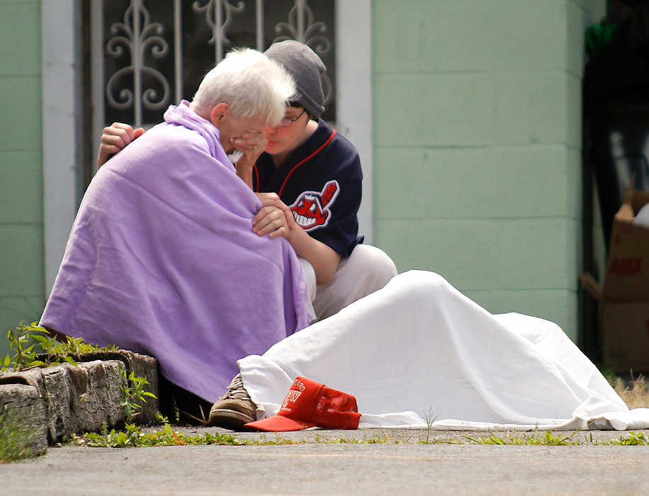 First Place, Spot News - Small Market - Robert K. Yosay / The (Youngstown) VindicatorA wife is consoled  after a friend found her elderly husband who apparently died on the sidewalk next to her home.