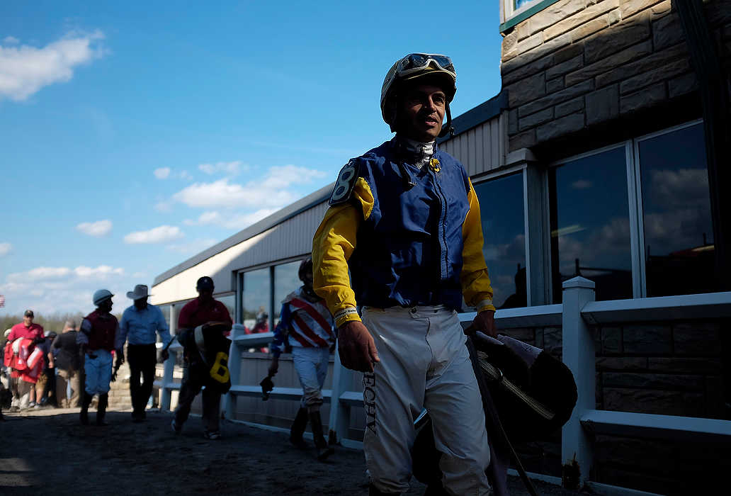 First Place, Ron Kuntz Sports Photographer of the Year - Eamon Queeney / The Columbus DispatchJockey Ramon Rechy walks off the track for the last time after the final race at Beulah Park in Grove City. Edgar Paucar (10) riding Rookie Gladden won the final $50,000 Babst/Palacio Stakes race. After 91 years, Ohio's first thoroughbred track held its final race day before closing its doors for good. A large crowd gathered to take it all in and place their last bets during Kentucky Derby day. 
