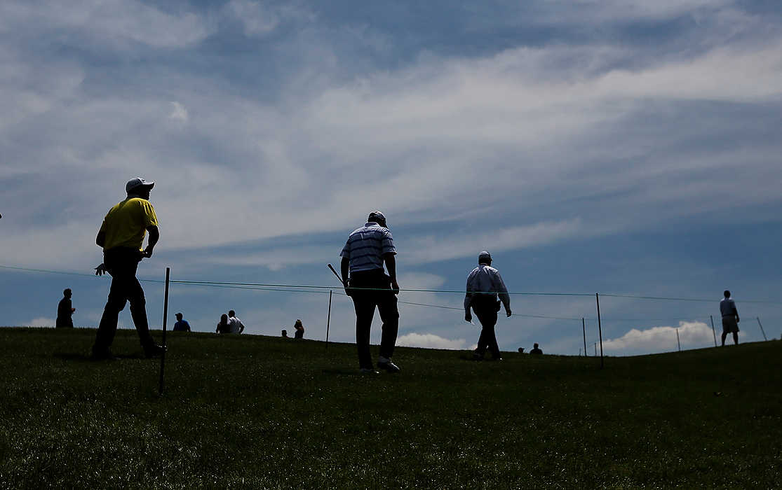 First Place, Ron Kuntz Sports Photographer of the Year - Eamon Queeney / The Columbus DispatchFor a week near Memorial Day every year Dublin, Ohio becomes the center of the golf world. Professionals come from around the world to compete in the Memorial Tournament at legendary golfer Jick Nicklaus' Muirfield Village Golf Club. Hideki Matsuyama defeated Kevin Na in a sudden death playoff match to seal his win of the Memorial Tournament.  Ben Curtis (right) and Bo Van Pelt (left) head to the 10th tee during the final round.