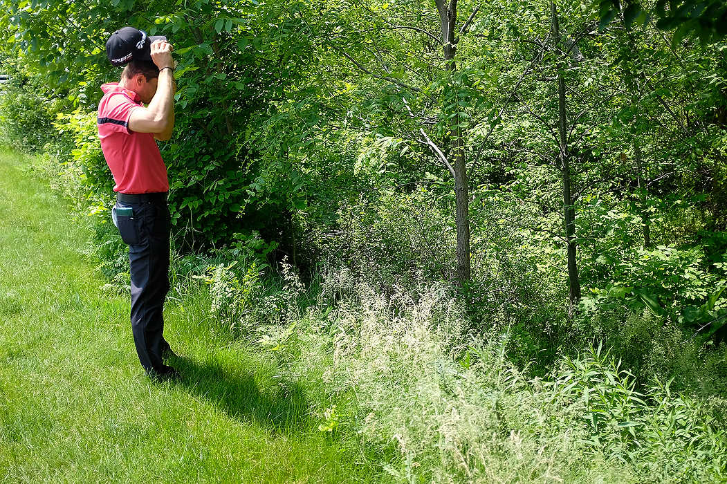 First Place, Ron Kuntz Sports Photographer of the Year - Eamon Queeney / The Columbus DispatchCamilo Villegas reacts as he looks for his ball in the woods just off the 17th fairway during the first round of the Memorial Tournament at Muirfield Village Golf Club in Dublin. Rory McIlroy led at the end of the first round after shooting nine under par. 