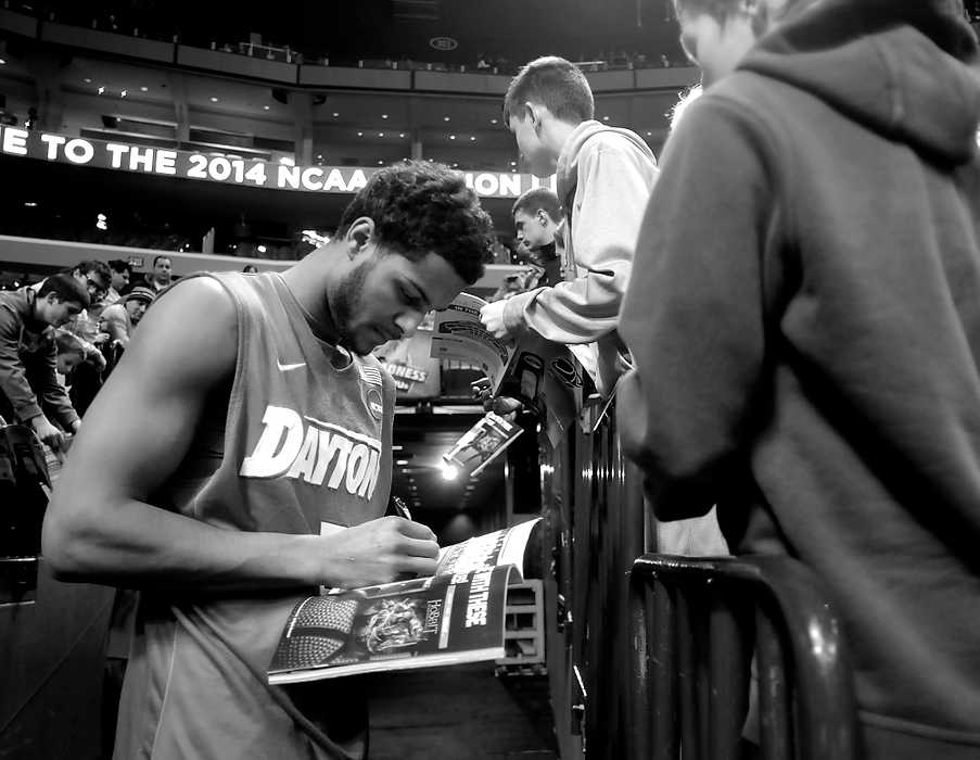 Second Place, Ron Kuntz Sports Photographer of the Year - Erik Schelkun / Elsestar ImagesAfter defeating Ohio State in their first game of the NCAA tournament, The Dayton Flyers became the cinderella story of the tournament and had request for autographs everywhere they went. Here, Devin Oliver signs a program before the start of their game against Syracuse in Buffalo, New York.