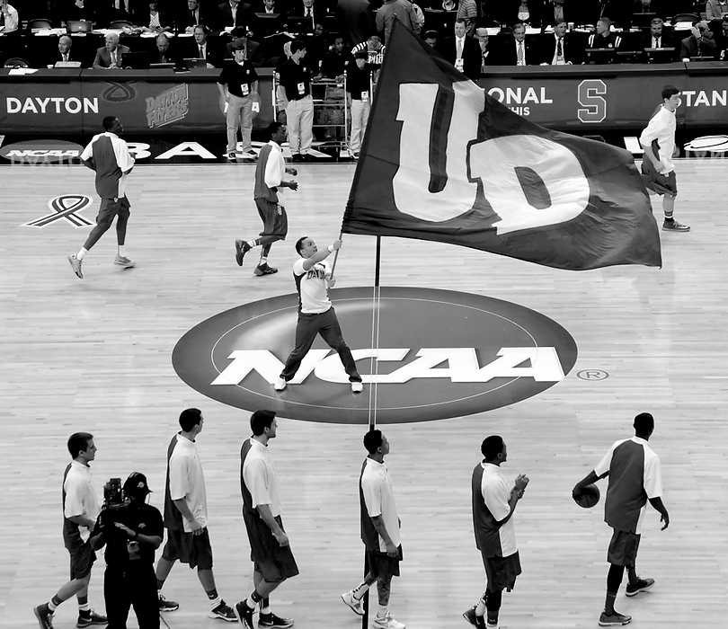 Second Place, Ron Kuntz Sports Photographer of the Year - Erik Schelkun / Elsestar ImagesA cheerleader waves a UD flag as the Flyers warm up prior to their Sweet Sixteen matchup against Stanford in Memphis, TN. 